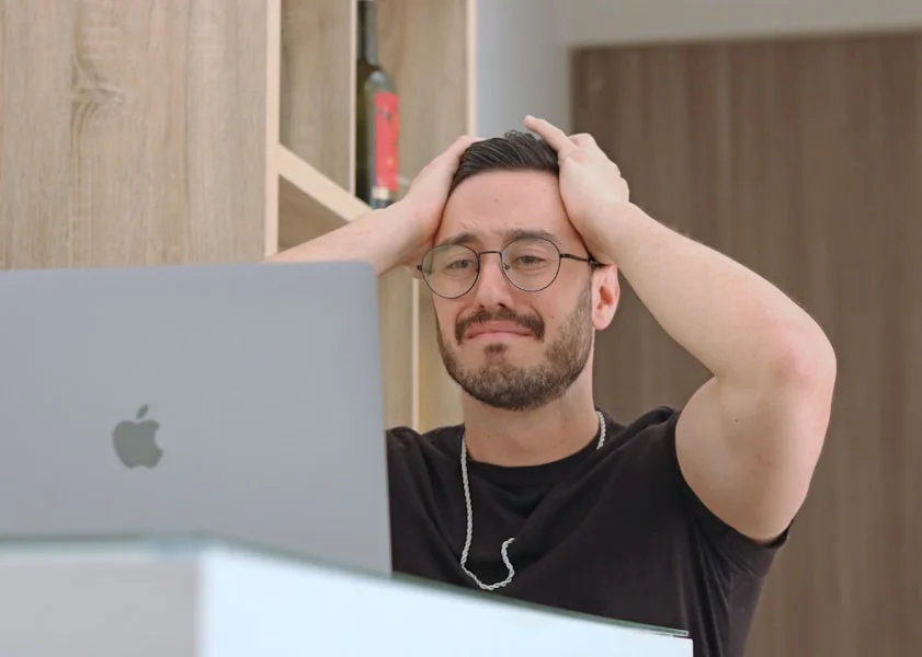 Common moving mistakes – stressed person at laptop